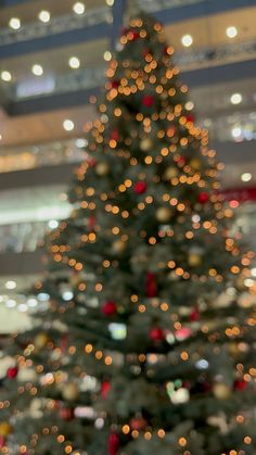 a christmas tree with lights in the background