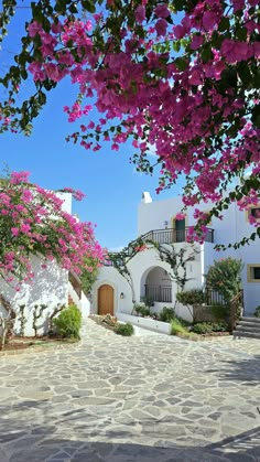 a white building with pink flowers on it