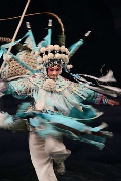 a man in costume is dancing with feathers