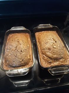 two pans filled with baked food sitting on top of a stove next to each other