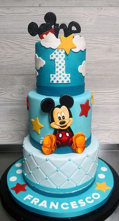 a mickey mouse birthday cake with the number one on it's top and stars