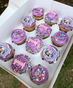 a box filled with lots of cupcakes covered in frosting