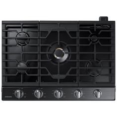 a black gas stove top with four burners