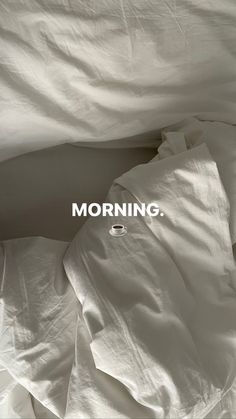 an unmade bed with the words morning on it