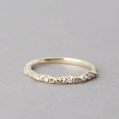 a gold ring with five diamonds on it