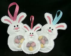 three white bunny ears with pink bows and eggs in the shape of two bunnies