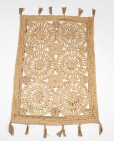 a piece of jute with tassels and holes in the middle on a white background