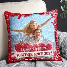 a personalized pillow on a couch with the image of a man and woman in red sequins