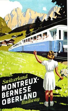 a woman in white dress standing next to a blue and white train with mountains in the background