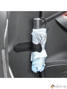 an umbrella hanging on the side of a car door handle with it's cover pulled up