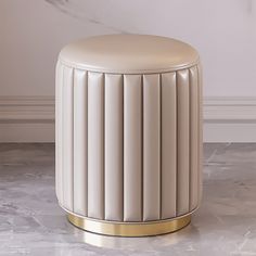 a white stool sitting on top of a marble floor