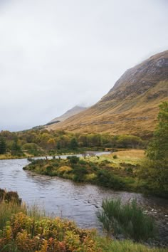 a river running through a lush green valley