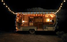 an rv parked in the dark with lights on it