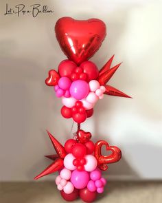 a bunch of balloons that are in the shape of birds and hearts on a table