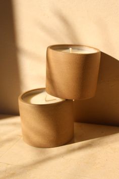 two candles sitting next to each other on a table