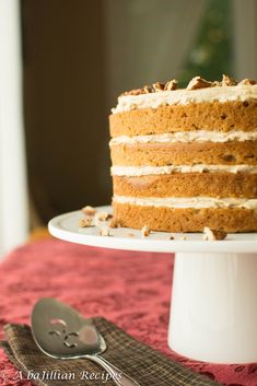 a cake sitting on top of a white plate next to a knife and fork in front of it