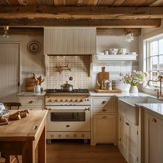 a kitchen with an oven, sink and counter tops in white painted wood paneling