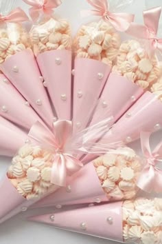 pink and white candy cones wrapped in cellophane with bowknots on them