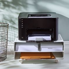 a printer sitting on top of a stack of papers