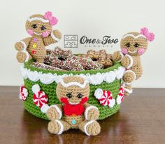 two teddy bears are sitting in a green basket with candy canes and candies