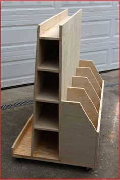 a wooden shelf with several compartments in front of a garage door