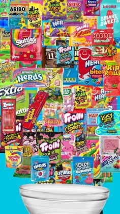 a toilet with many different types of candy on it's lid and in front of a blue background