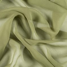 Mood's Premium Pesto Silk Crinkled Chiffon is a sheer, lightweight and ethereal fabric with a subtle, crinkled texture. An excellent choice for fluid, top-weight garments, overlays, flowing scarves, and sheer insets such as ruffle details and draped extensions. 

Note: Dye lots are subject to change up to 10% in either direction. Ordering swatches is HIGHLY recommended for these products. Luxury Sheer Chiffon Dress For Wedding, Luxury Elegant Summer Tulle Fabric, Stretch Chiffon Fabric, Tan Chiffon Fabric, Cotton Silk Clothing Fabric, Luxury Green Chinon Sets, Luxury Silk Chiffon Dress, Luxury Flowy Silk Chiffon Dress, Luxury Sheer Fitted Tulle Fabric