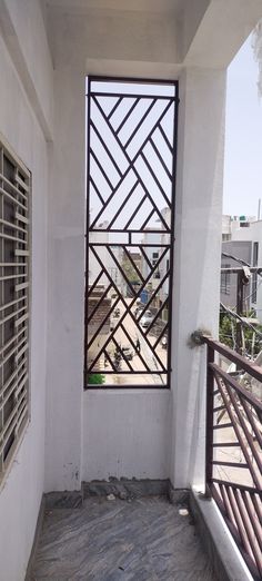 an open window on the side of a building with metal bars in front of it