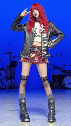 a woman with red hair is dressed in punk clothing and knee high boots while posing for the camera