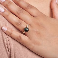 This 9.0-10. mm AAA quality Tahitian pearl ring showcases the pure organic beauty of an exotic Tahitian pearl. The flawless pearl appears to float above the gold, yet is securely attached by a strong post. The classic-style ring features a solid 14-karat gold band that is set with 0.25 carats of diamonds. The ring setting is made in-house and is composed of solid 14 karat gold. We use an extra-fine diamond grade (VS1-G), which is normally reserved for solitaire settings. It's rare to see this gr Luxury Tahitian Pearl Rings Fine Jewelry, Luxury Classic Open Pearl Ring, Luxury Tahitian Pearl Ring, Luxury Elegant Tahitian Pearl Rings, Luxury Classic Pearl Ring With Single Cut Diamonds, Yellow Gold Tahitian Pearl Ring, Gold Tahitian Pearl Ring Fine Jewelry, Wedding Tahitian Pearl Ring In Yellow Gold, Wedding Yellow Gold Tahitian Pearl Ring