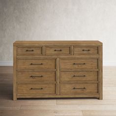 a wooden dresser sitting on top of a hard wood floor next to a white wall