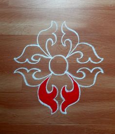 a white and red design on a wooden floor