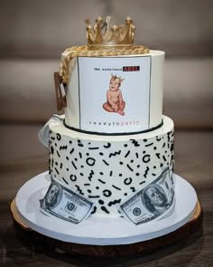 a cake with money and a crown on top