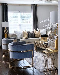 a living room filled with lots of furniture next to a window covered in drapes