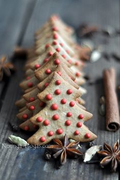 cinnamon stick christmas trees on a table with cinnamon sticks and star anisette decorations