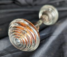 an old glass door handle on a black cloth