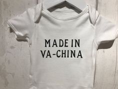 A funny and novelty baby vest is a great gift for those new parents, or as a baby shower gift.The vest has the quote 'made in va-china'Bodysuit is 100% cotton with poppers to the bottom.Available in: first size, 0-3 months, 3-6 months (can do larger sizes on request).Vest is in white, and the quote is available in different colours, see photo for colour charts, if your colour is not listed please message me and I’ll be happy to help. Wording is applied using heat transfer vinyl.Vest is machine w Vinyl Vest, Superhero Door, Superhero Names, Baby Vest, Gifts For New Parents, Personalized Wall, Funny Baby, Heart Earrings Studs, Transfer Vinyl