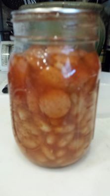 a jar filled with lots of food sitting on top of a table