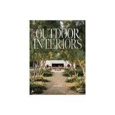 the cover of outdoor interiors magazine, with trees and bushes in front of an open fire place