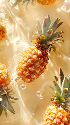 several pineapples floating in the water with bubbles