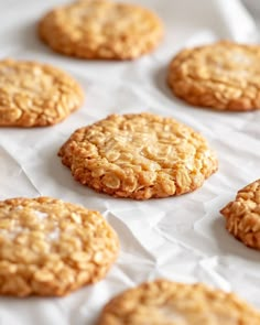 some cookies are sitting on a piece of wax paper