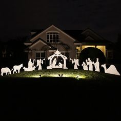 a lighted nativity scene in front of a house