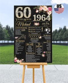 a black and gold 50th anniversary sign with flowers on it