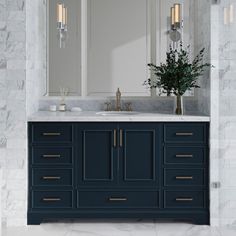 a bathroom vanity with marble counter tops and blue cabinets