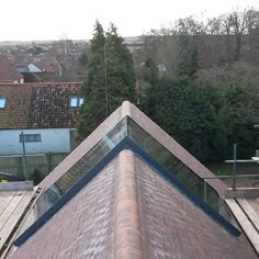 the top of a building with a skylight on it's roof and trees in the background