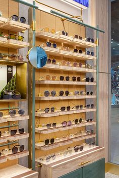 the display case is filled with many pairs of sunglasses