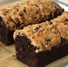 some brownies sitting on top of a pan with one cut in half and the other partially eaten