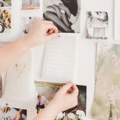 a person is holding an open book with pictures on the wall behind them and photos hanging up