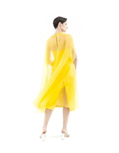 Dune Yellow cape gown made from silk organza, features wide A-line silhouette, round neck, midi length, hook-buttoning on the back and no lining.Offered with matching bustier midi dress sold separately (as shown on pictures) or with lining on request. Flower application is on request with no surcharge. 100% Silk organzaNo liningHook button on the backDry cleanMade in Milan