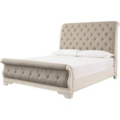 an upholstered bed with white linens and tufted headboard, made in the usa